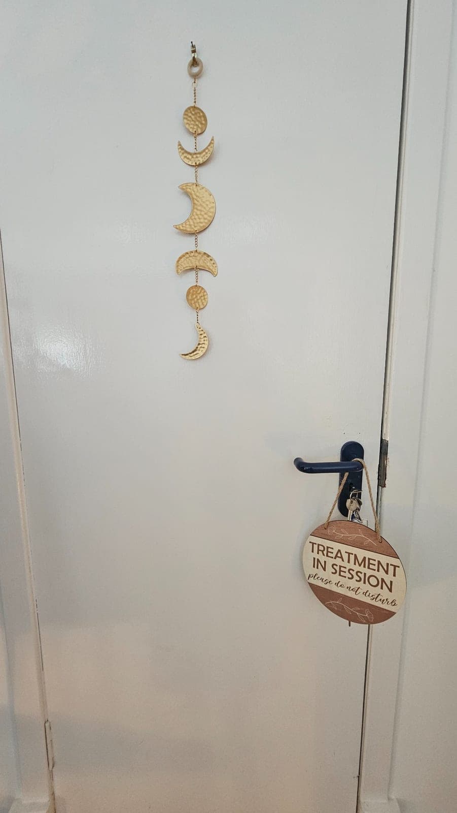 Treatment room door with a 'treatment in session' sign at The Reset Room Glasgow
