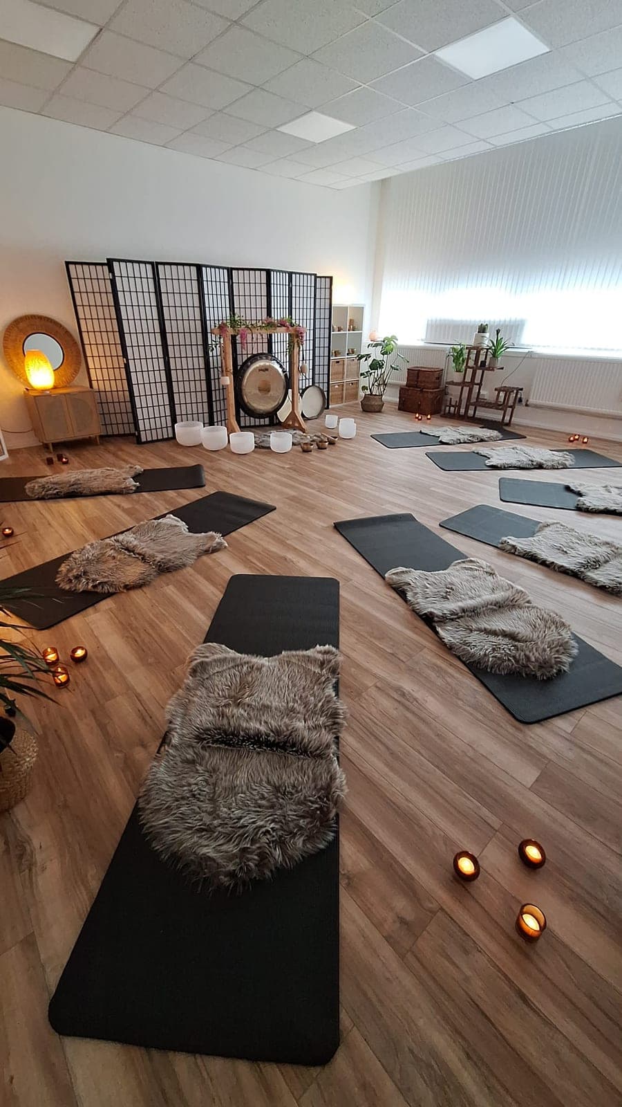 Sound bath mats arranged in a small group around the gong at The Reset Room Glasgow
