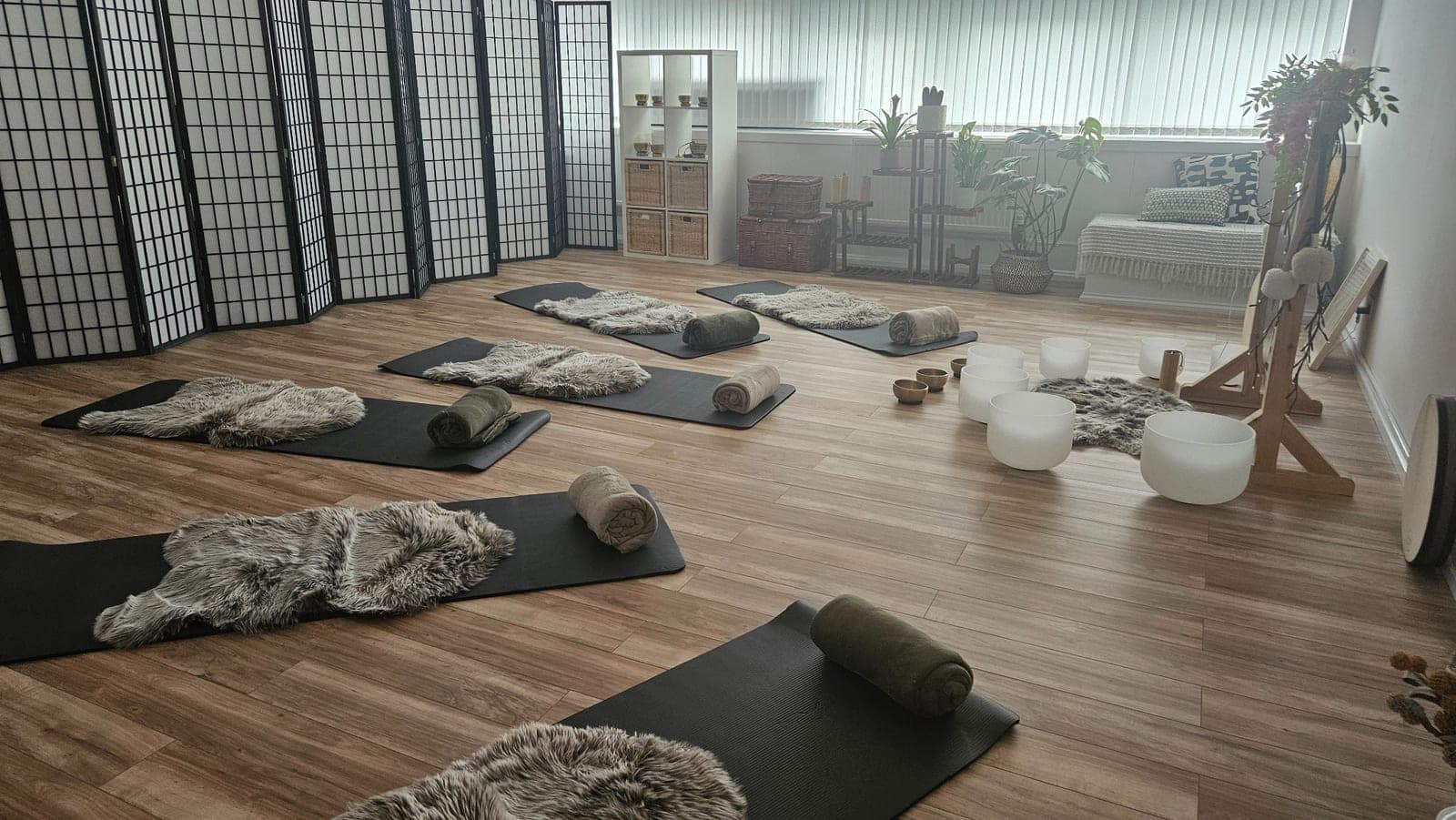 Mats, rolled blankets and singing bowls prepared for a sound bath in Glasgow