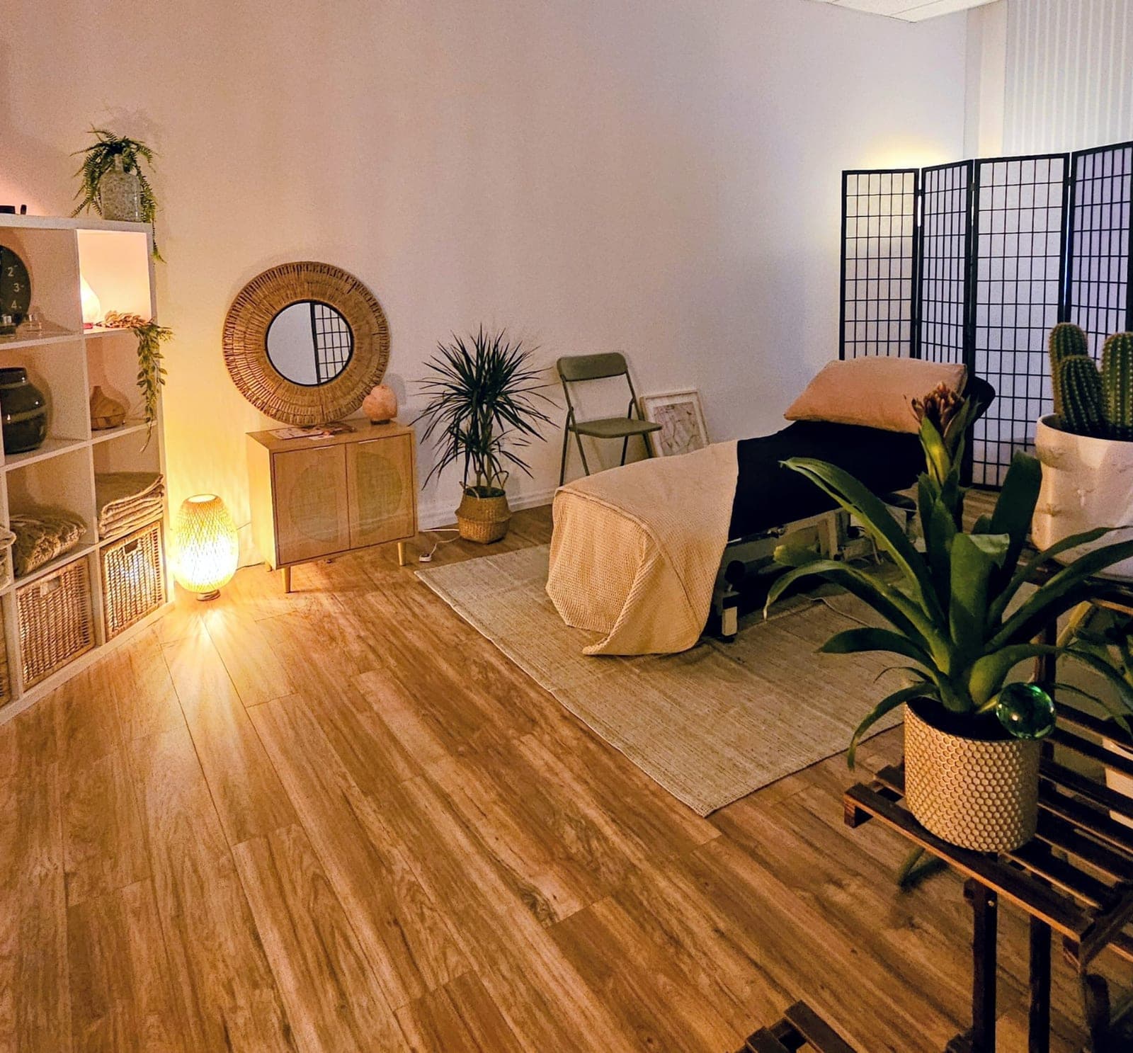 Warmly lit treatment room with massage table at The Reset Room Glasgow