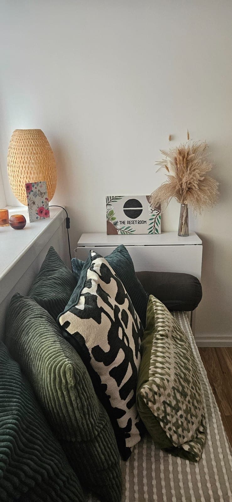 Cushioned seating and The Reset Room sign in the studio's waiting area